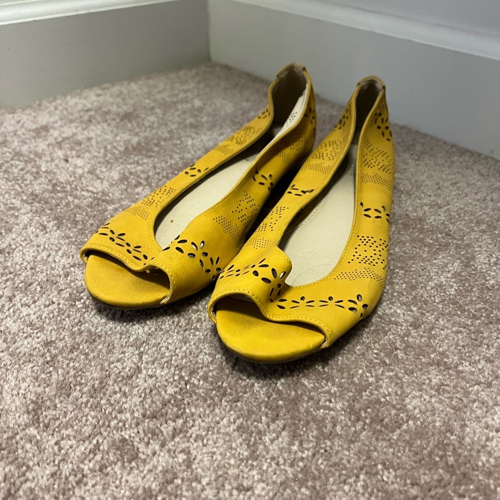 Mustard cut out detailed flats with open toes.